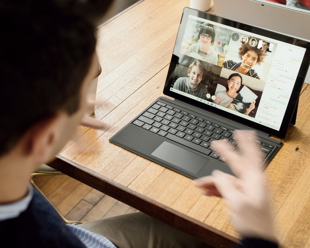 Laptop showing online webinar video conference with technology speakers
